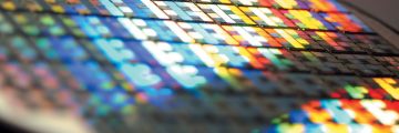 Extreme closeup of tiny, colorful glass "tiles" of semiconductor