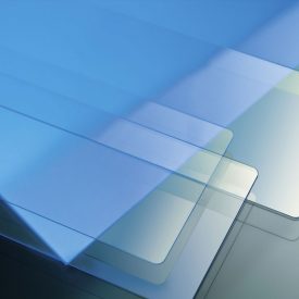 Long, rectangular sheets of glass in bluish-yellow light