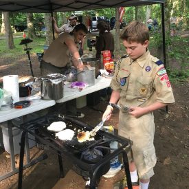 Two Boy Scouts prepare breakfast for the group during Memorial Day weekend in Greenbelt Park.