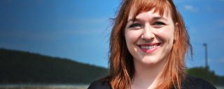 Closeup of Jackie, a Corning intern, hill, blue sky background