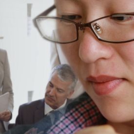 Montage: woman in glasses, group of people meet in background